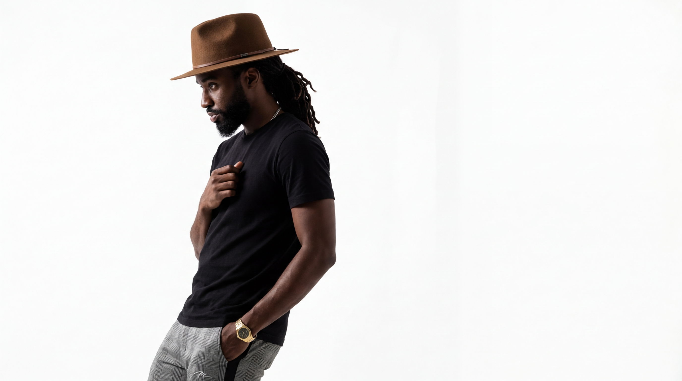 Model with locs wearing a hat in studio